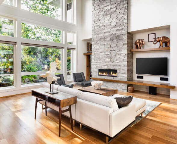 Large living room with multiple windows showing beautiful view